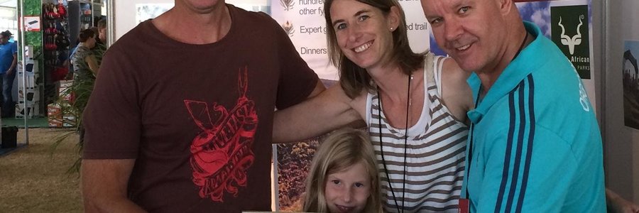 From the left: Sean and Michelle Privett, with their daughter, Emma, between them, receiving the award from the Getaway Show organiser